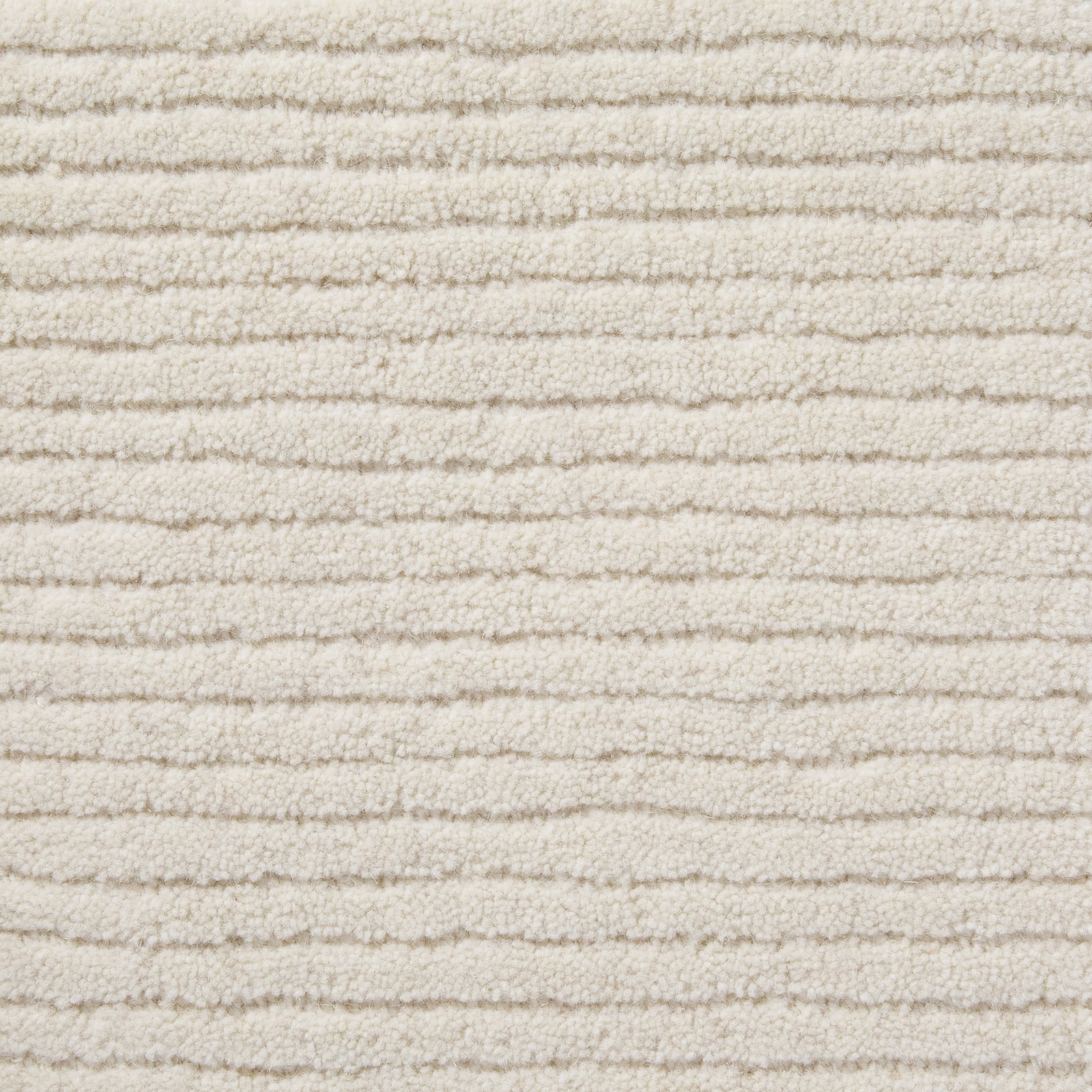 Warm vanilla cream carpet with irregular horizontal ridges and a softly looped texture