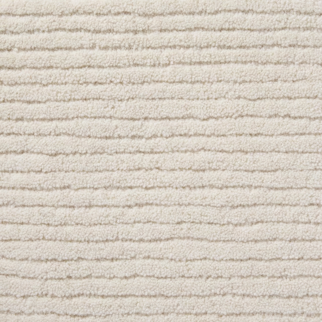 Warm vanilla cream carpet with irregular horizontal ridges and a softly looped texture