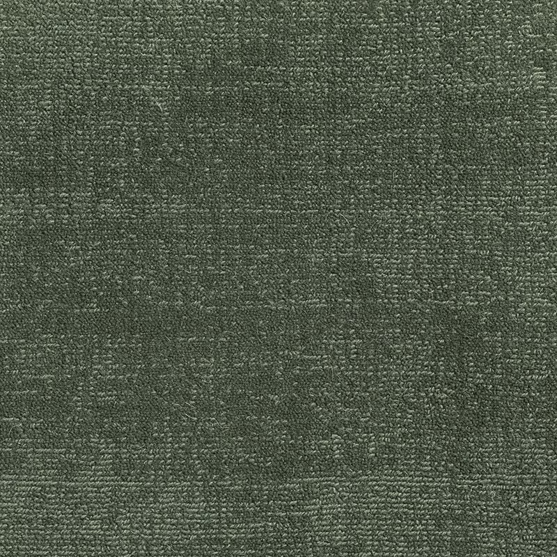 Close-up of Juniper’s deep olive-green carpet weave with mottled grey texture