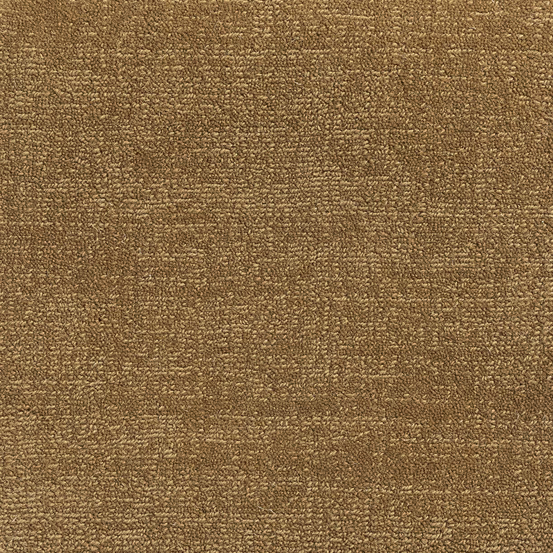 Close view of warm old-gold carpet weave with mottled ochre-brown texture