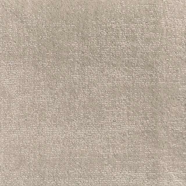 Soft stone-taupe carpet with dense looped texture and subtle mottled variation