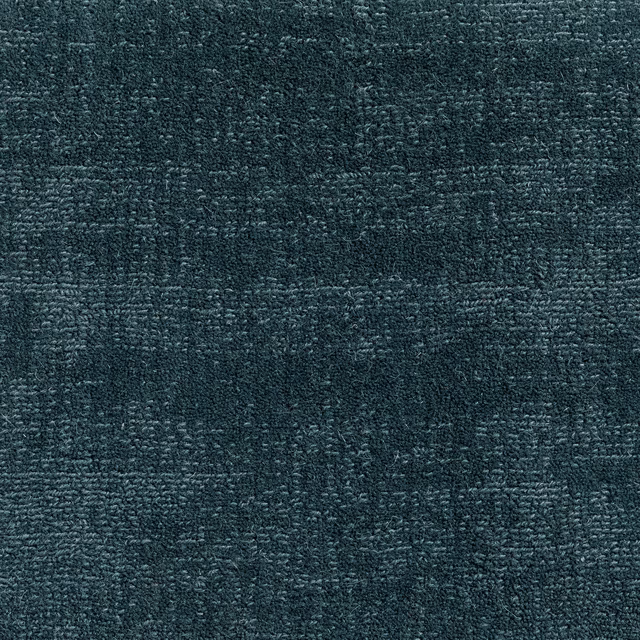Deep woad blue-green carpet with dense mottled weave and charcoal-textured shading