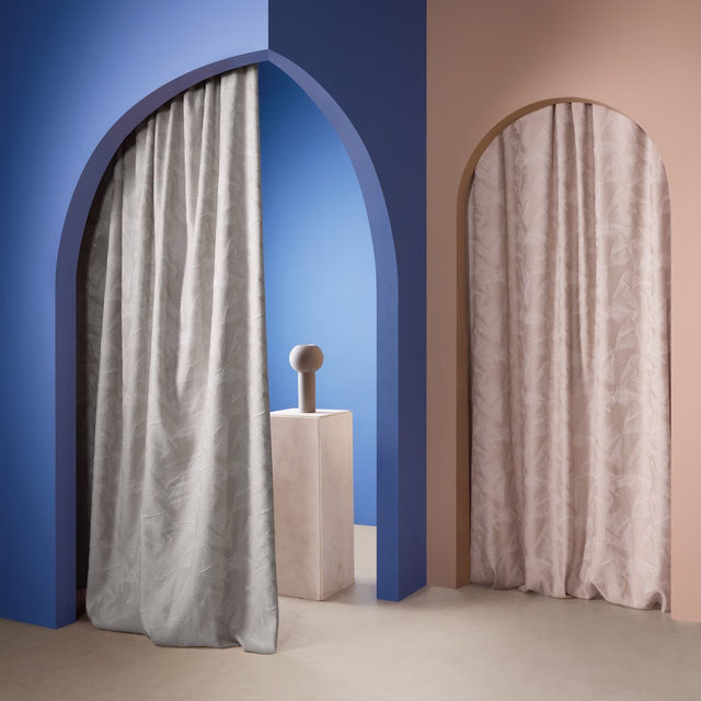 Cool silver-grey drapery with softly rippled vertical folds and a fluid sheen