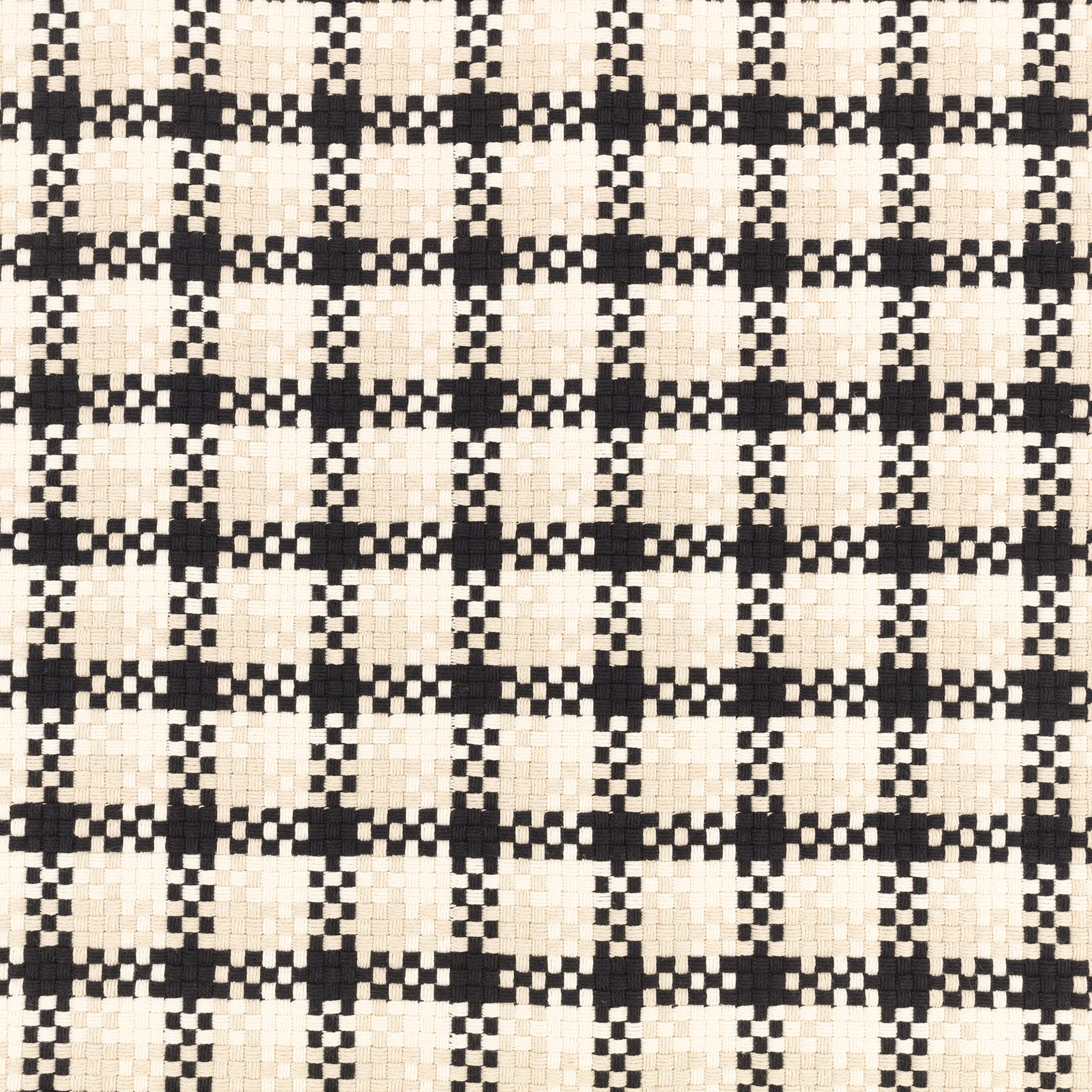 Close-up of black and ivory stepped geometric check woven fabric with chunky tactile texture