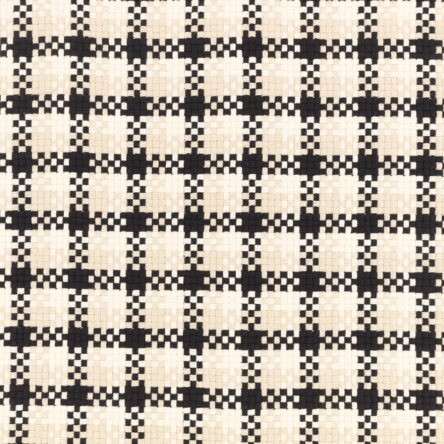 Close-up of black and ivory stepped geometric check woven fabric with chunky tactile texture