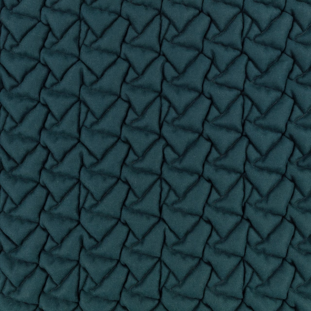 Deep kingfisher teal textile with raised, irregular geometric quilted texture