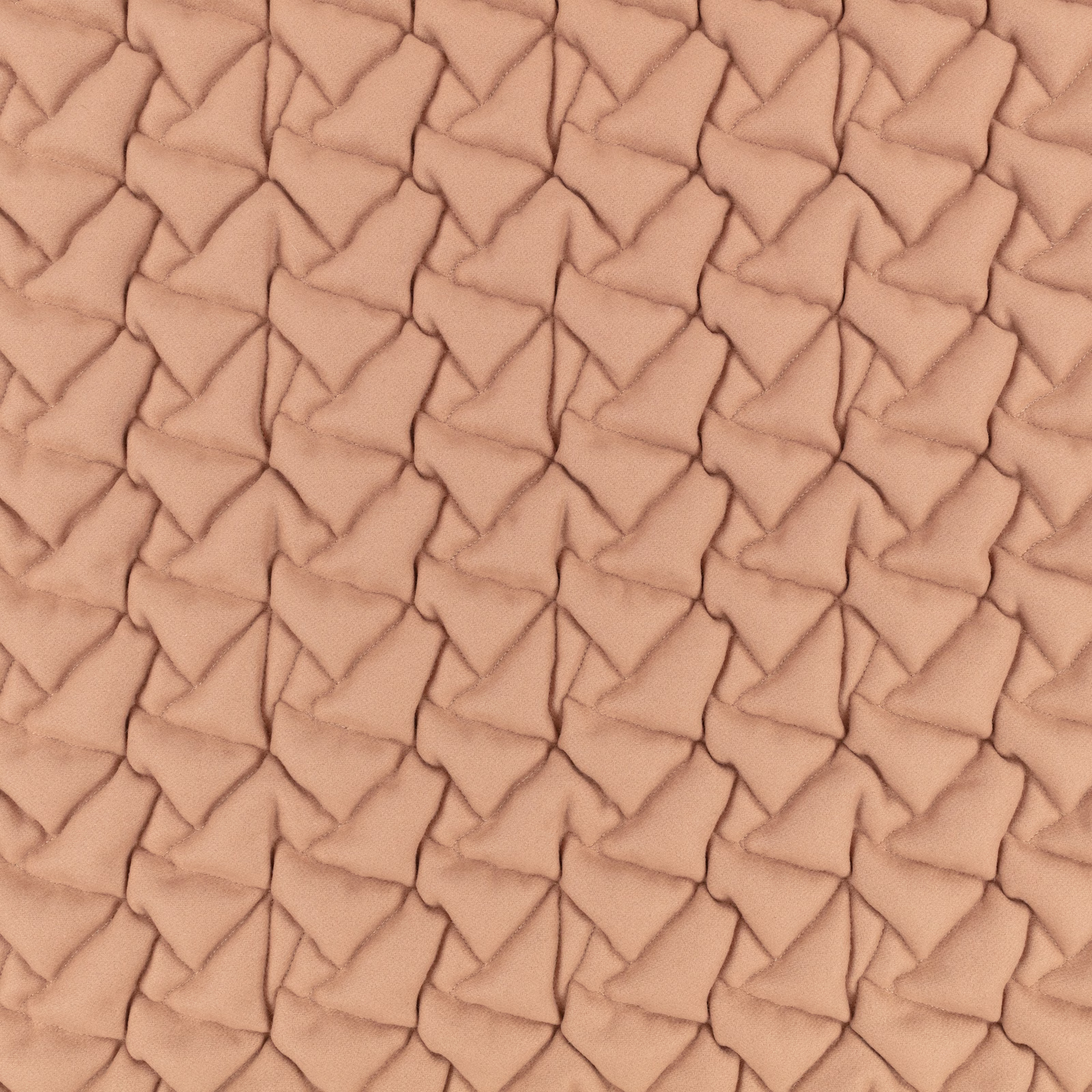 Warm rosewater peach fabric with raised, interlocking folded triangular texture