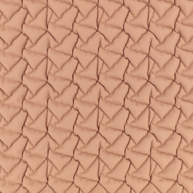 Warm rosewater peach fabric with raised, interlocking folded triangular texture