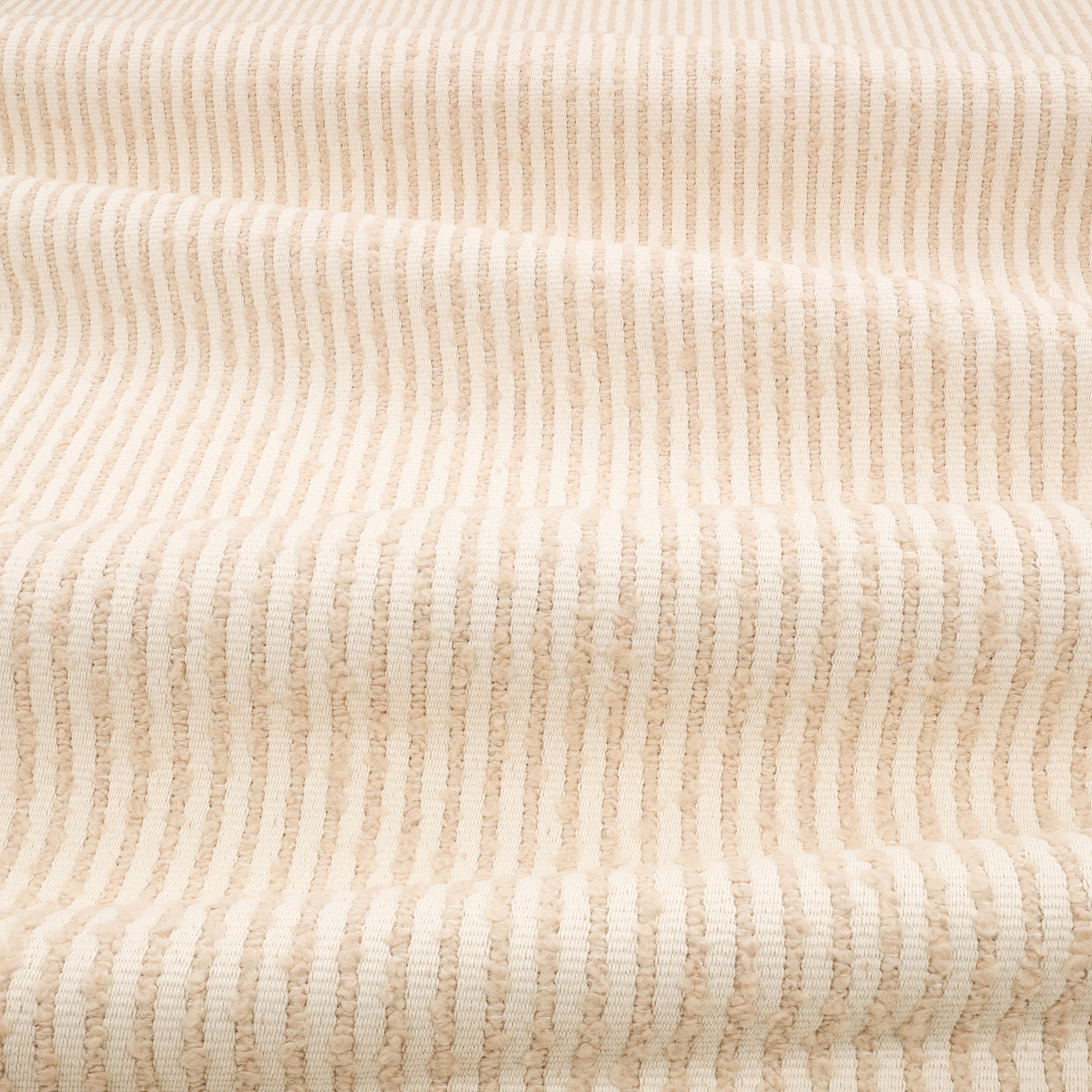 Chalky cream textile with irregular vertical ribs and softly nubby texture
