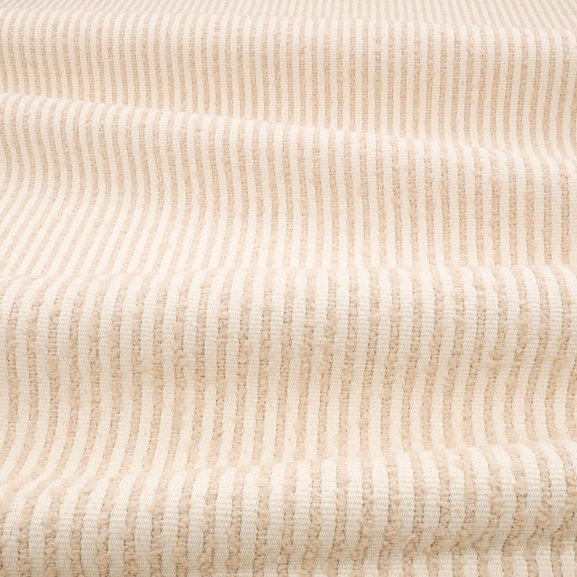 Chalky cream textile with irregular vertical ribs and softly nubby texture