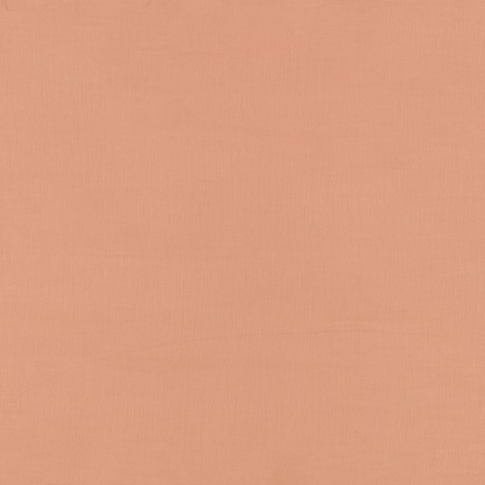 Close-up of muted coral-pink fabric with a delicate vertical plain weave