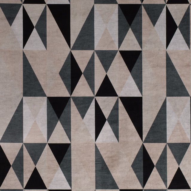 Warm biscuit geometric fabric with black, charcoal and pale grey triangular motifs