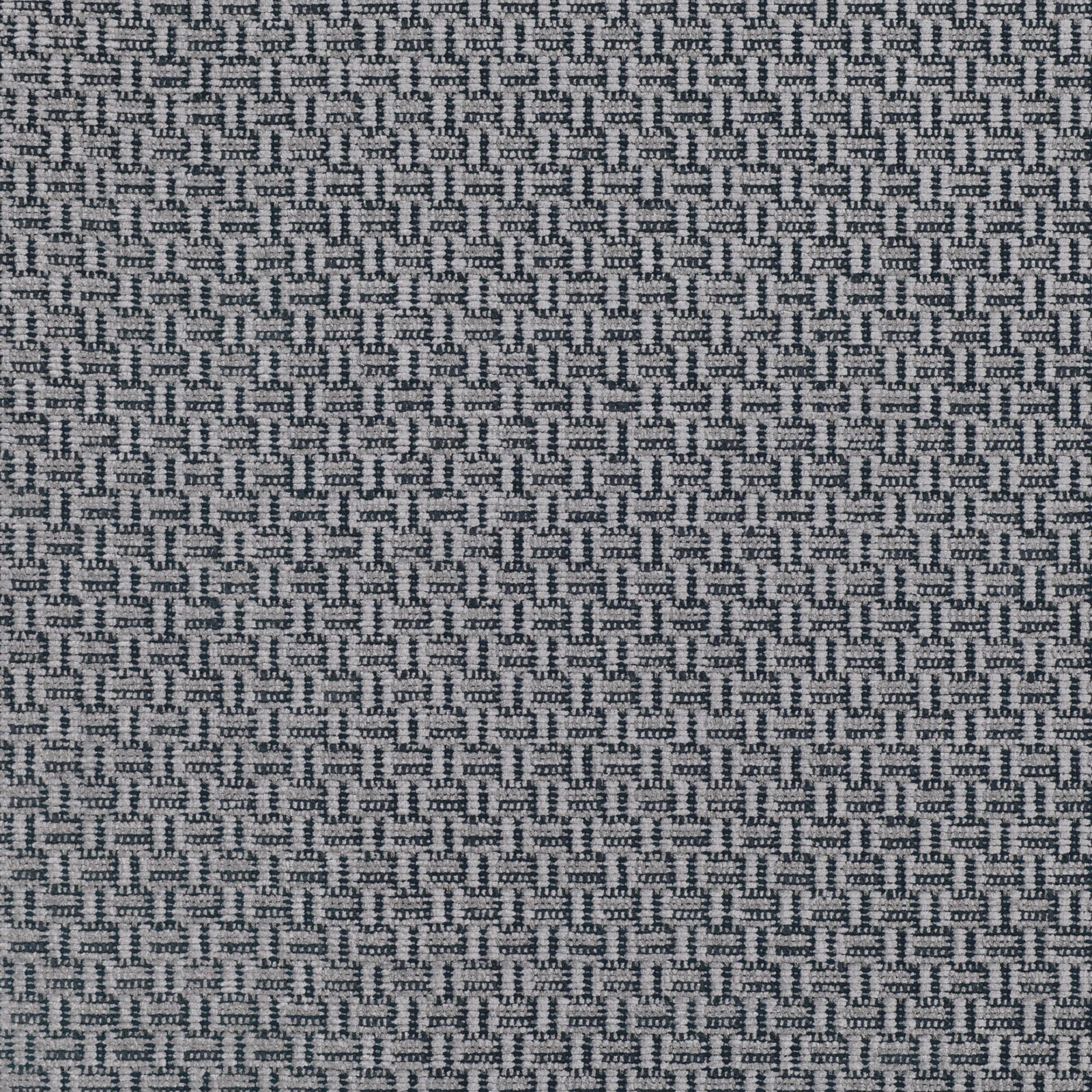Close-up of cool storm-grey fabric with dense interlocking geometric woven texture