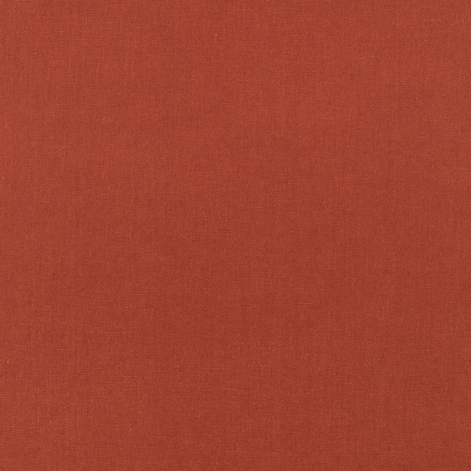 Warm terracotta-red fabric showing a subtle, fine woven texture in close-up