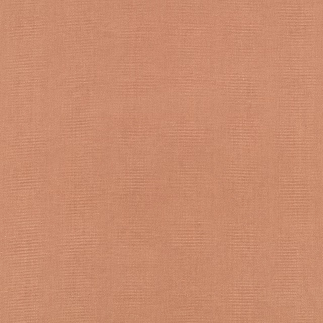 Close-up of muted salmon-pink plain weave with a soft, lightly varied texture