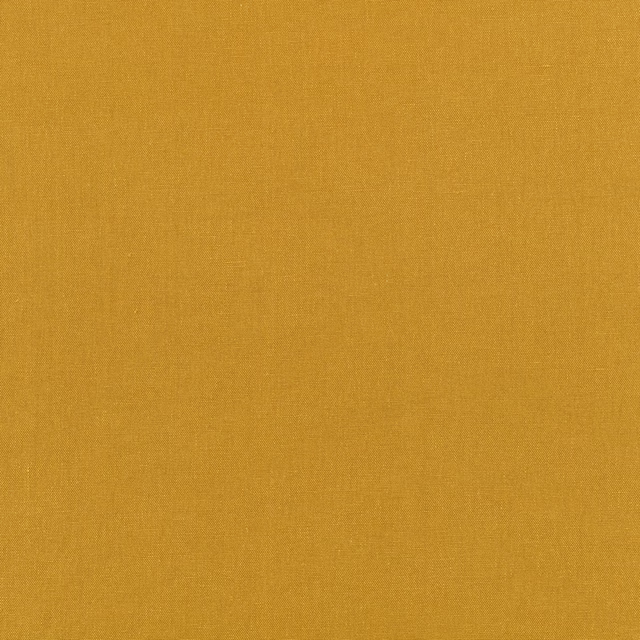 Close-up of warm ochre mustard fabric showing a fine, even plain weave