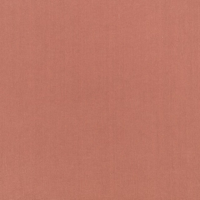Close-up of muted vintage rose fabric with a fine, softly textured plain weave