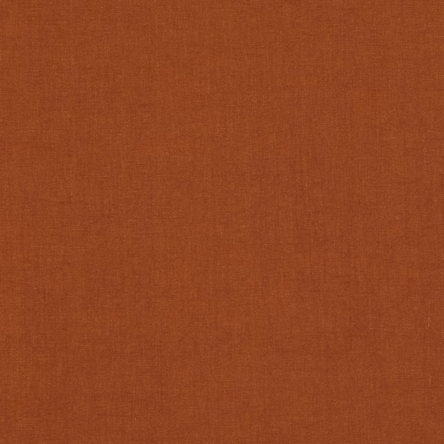 Close-up of warm burnt terracotta fabric with a fine, subtly textured plain weave