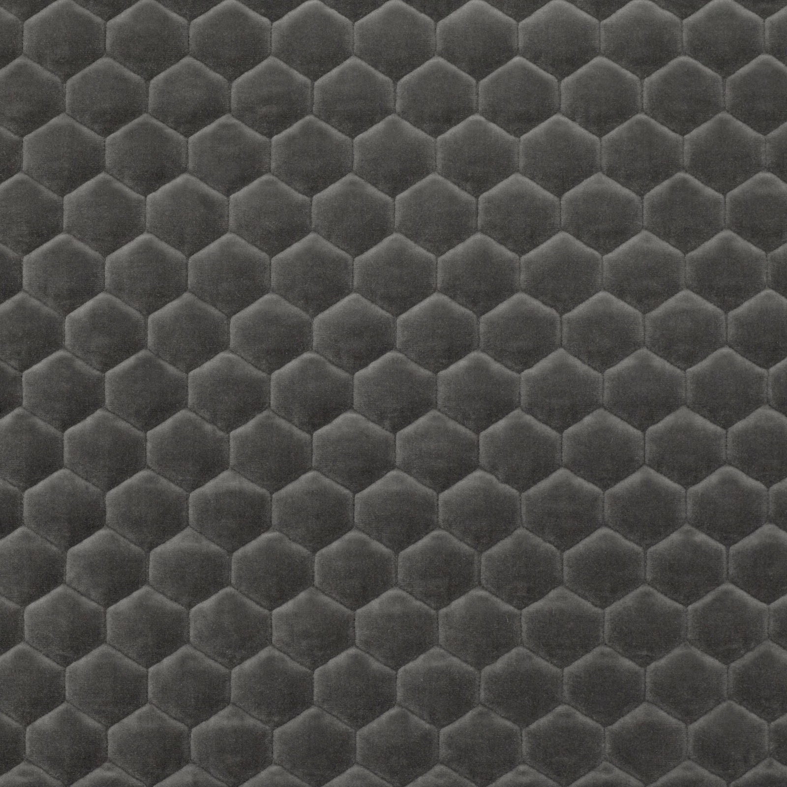 Deep anthracite plush fabric with repeated tonal hexagons and softly raised edges