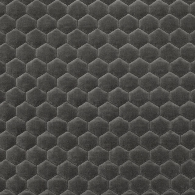 Deep anthracite plush fabric with repeated tonal hexagons and softly raised edges