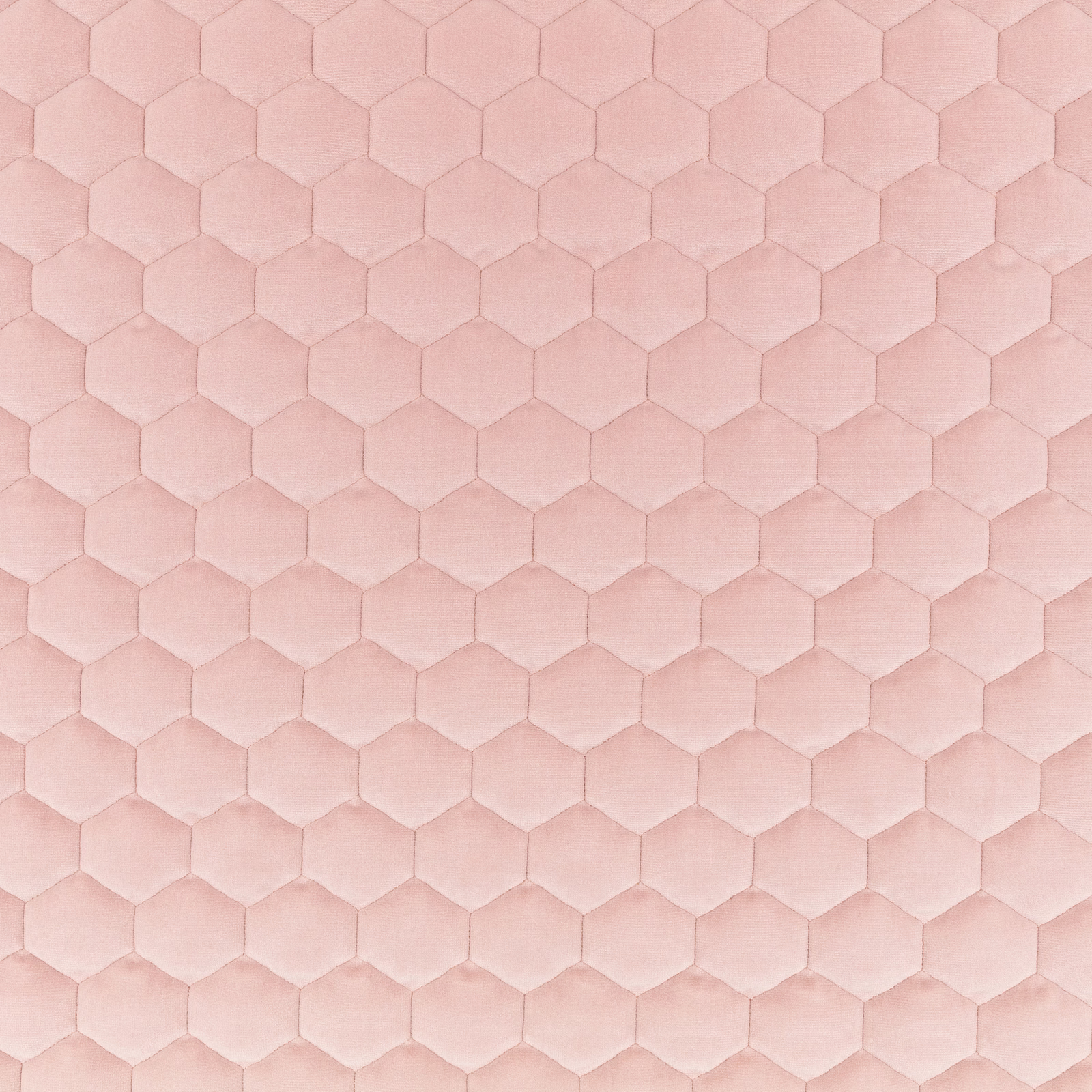 Pale blush pink fabric with tonal padded hexagons and a soft plush surface