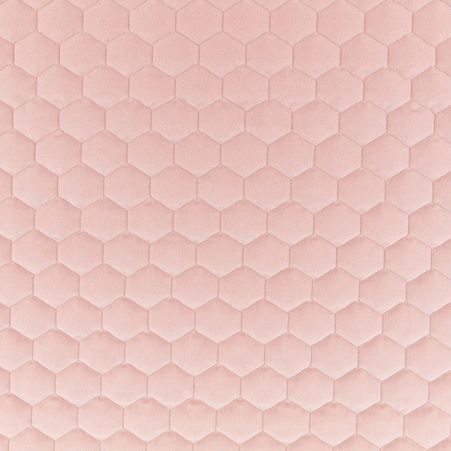 Pale blush pink fabric with tonal padded hexagons and a soft plush surface