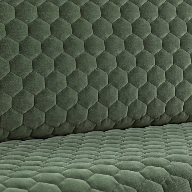 Muted eucalyptus-green quilted fabric with raised hexagonal cells and plush directional shading