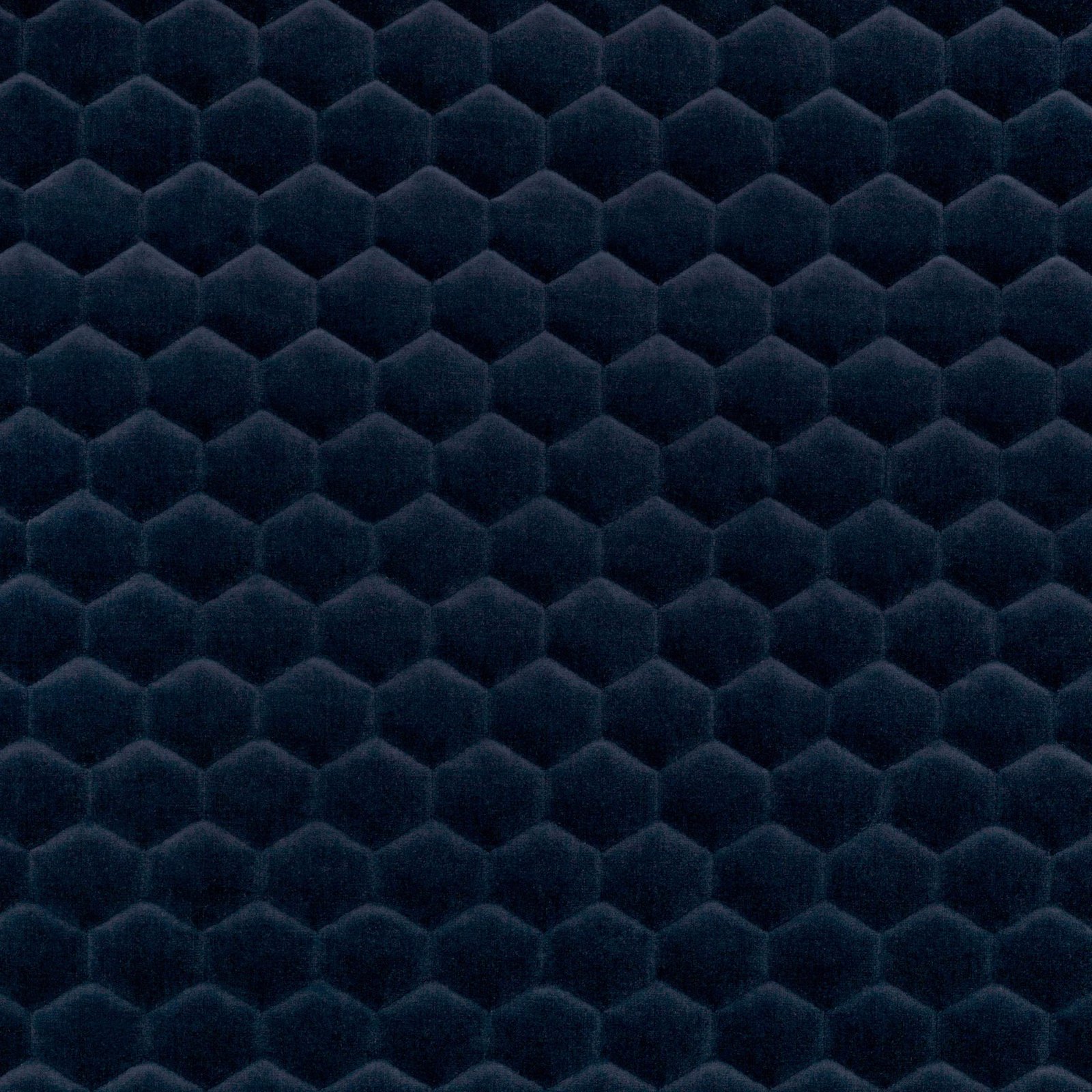 Deep marine-blue fabric with plush raised hexagonal cells and shadowed centres