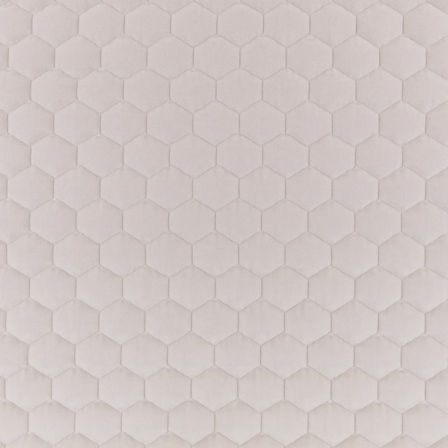 Pale warm-taupe fabric with softly raised repeating hexagonal honeycomb texture