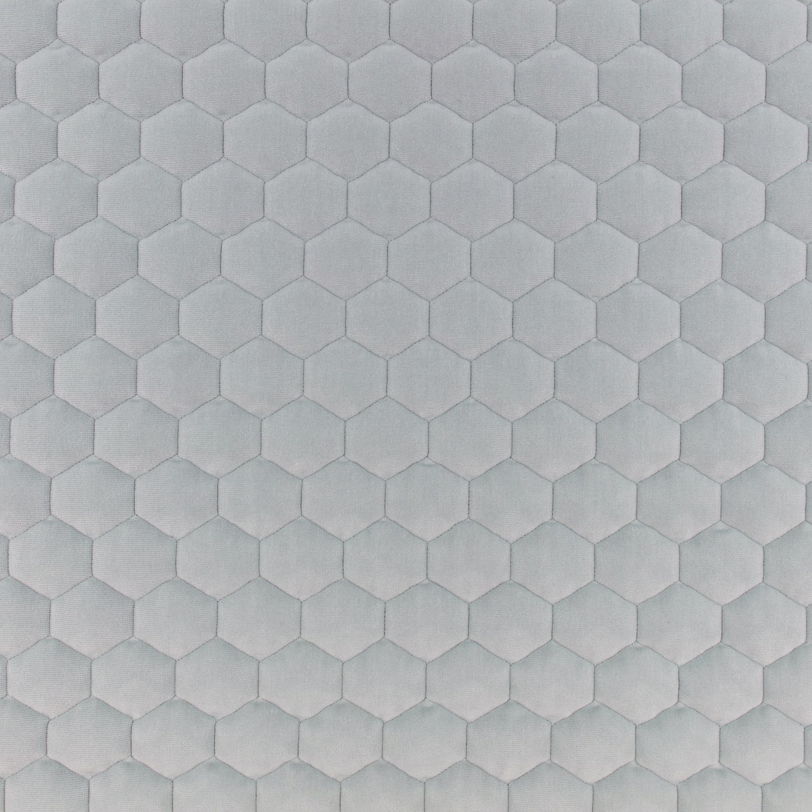 Pale blue-grey fabric with softly raised hexagonal honeycomb texture