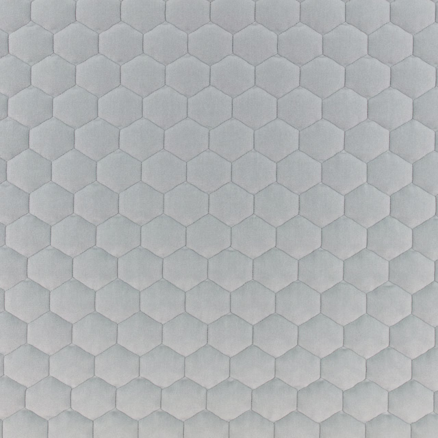 Pale blue-grey fabric with softly raised hexagonal honeycomb texture