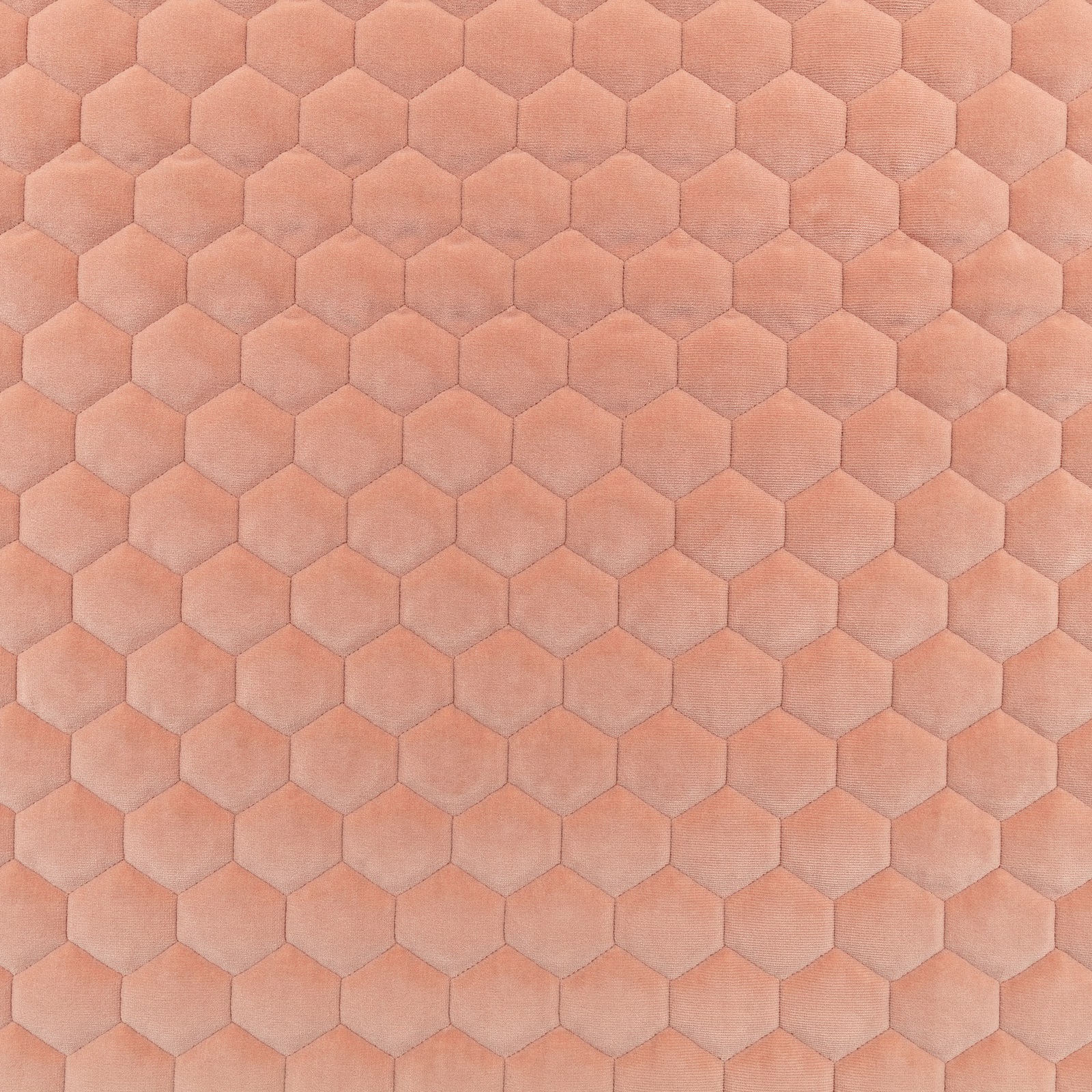 Peach-pink fabric with softly shaded hexagonal motifs and a plush surface