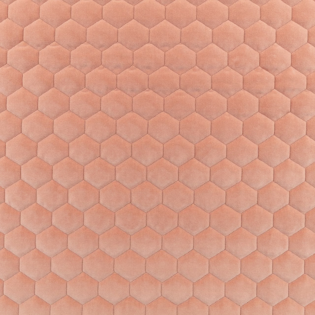 Peach-pink fabric with softly shaded hexagonal motifs and a plush surface