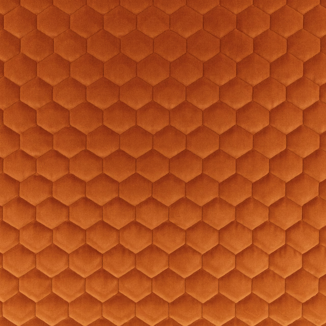 Burnt tangerine textile with a raised, honeycomb-like hexagonal surface