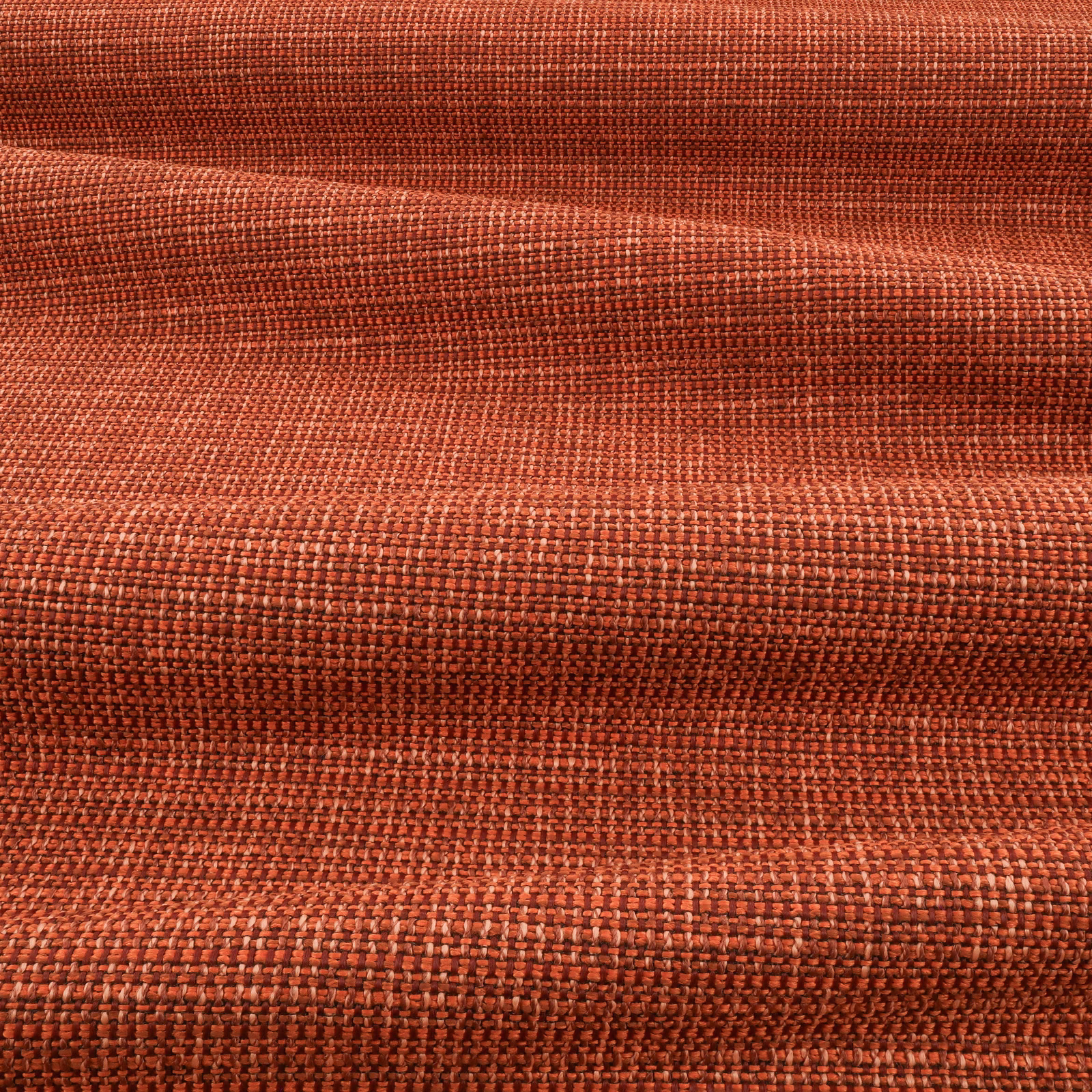 Burnt blood-orange woven textile with dense crosshatched texture and darker rust folds