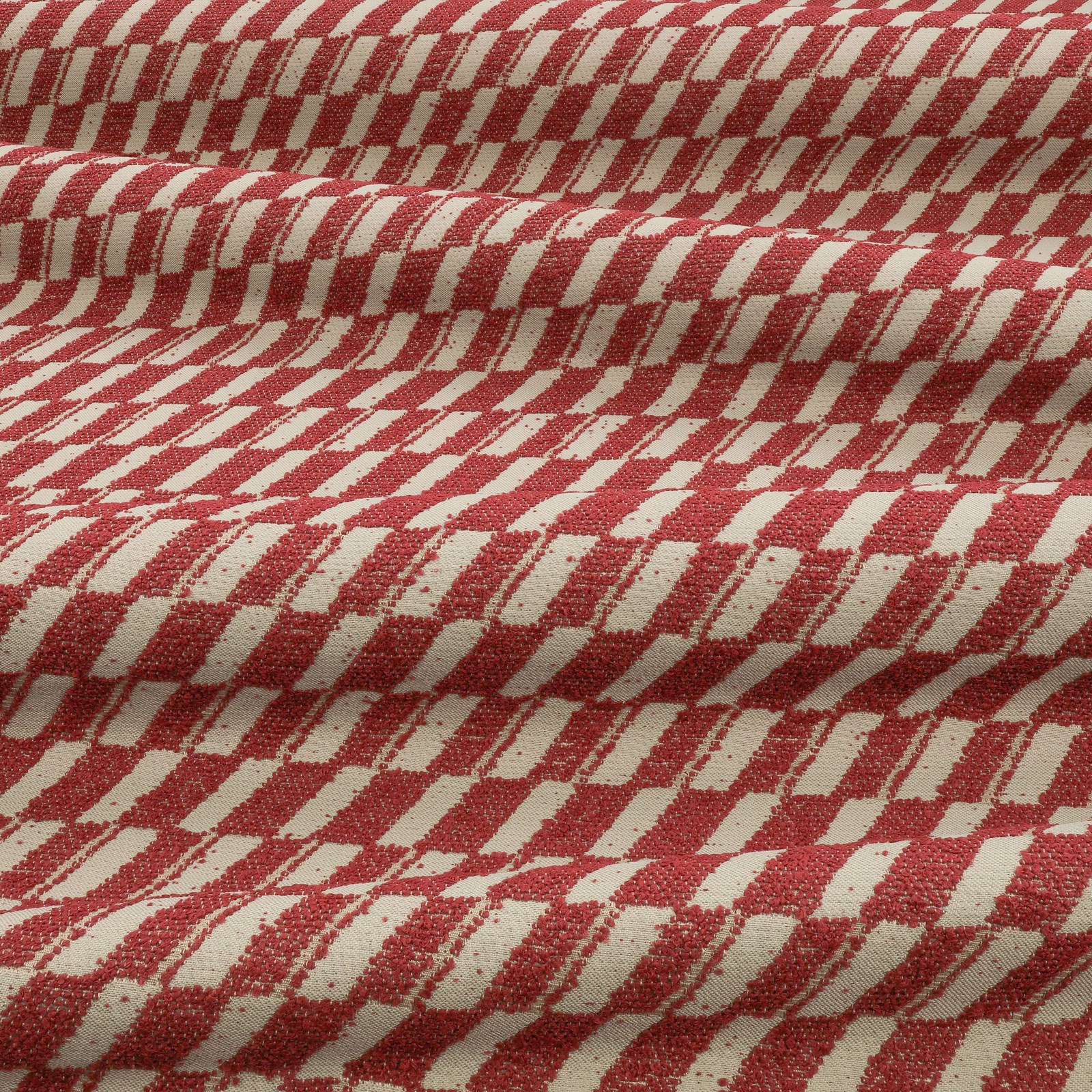 Muted berry-red and cream geometric weave shown in pronounced folded texture