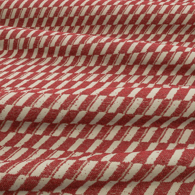Muted berry-red and cream geometric weave shown in pronounced folded texture