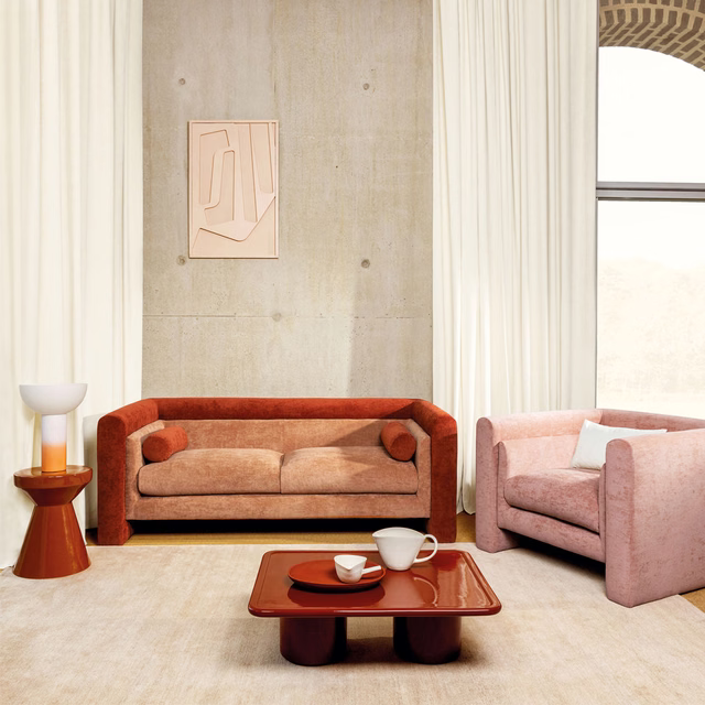 Warm amber-orange textured sofa upholstery with softly mottled, low-patterned surface