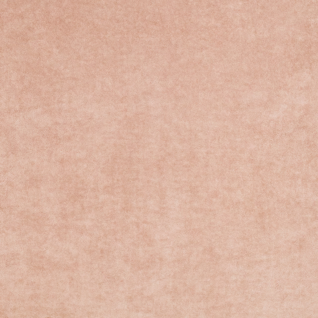 Close-up of warm dusty pink fabric with soft mottled, plush texture