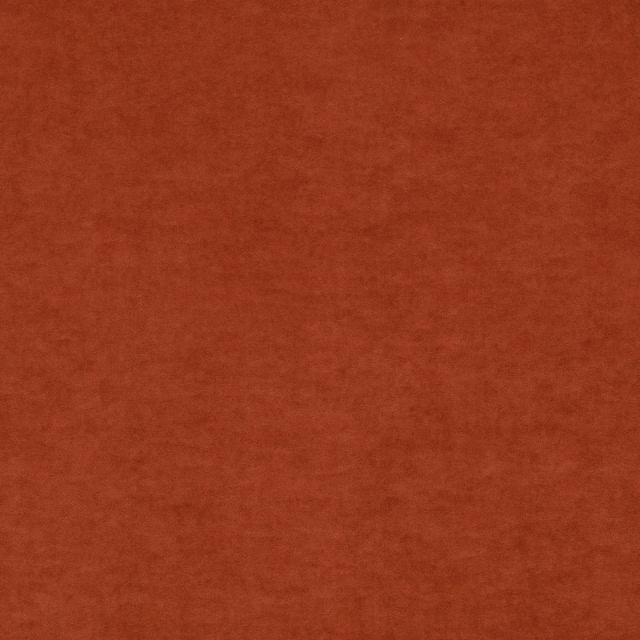 Close-up of warm rust terracotta fabric with softly brushed, mottled texture