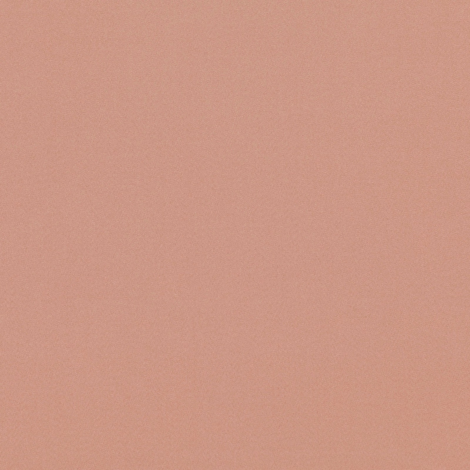 Close-up of plain muted clay terracotta fabric with a soft suede-like surface