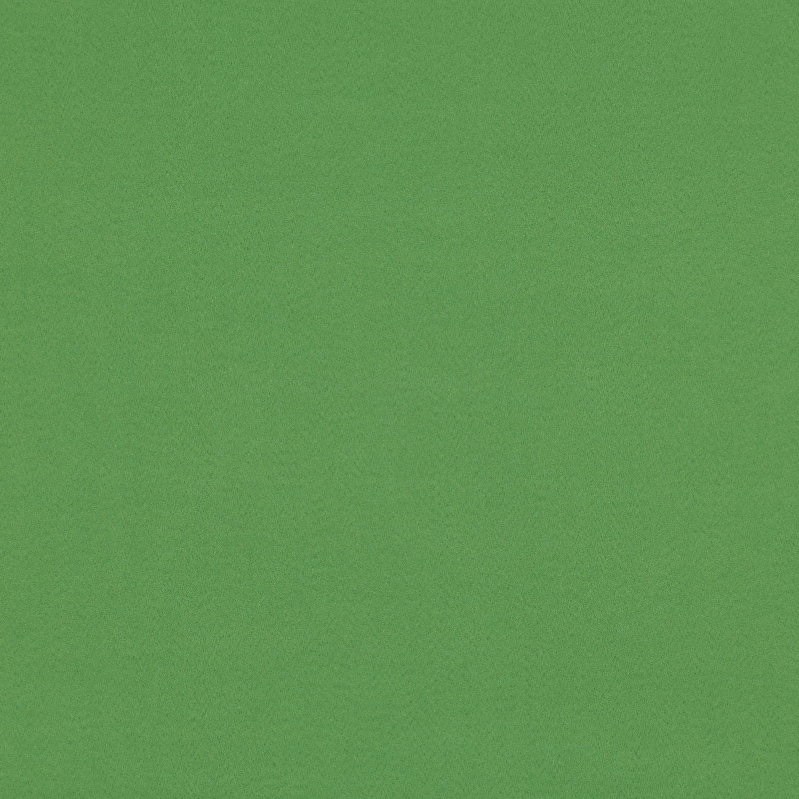Close-up of plain grass-green suede-look fabric with a fine, softly mottled surface