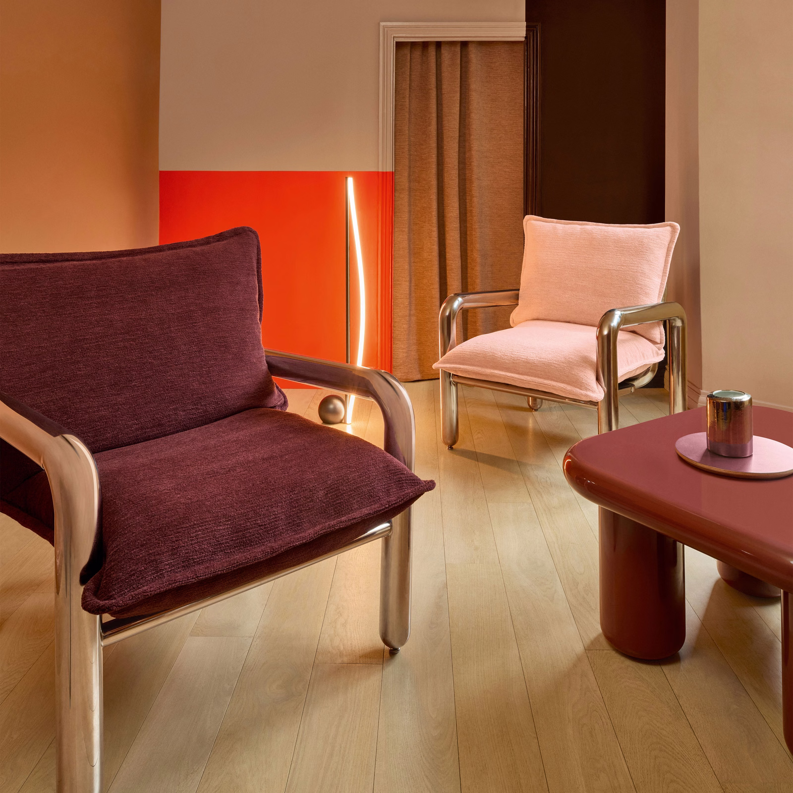 Deep fig-plum ribbed upholstery covering a contemporary lounge chair