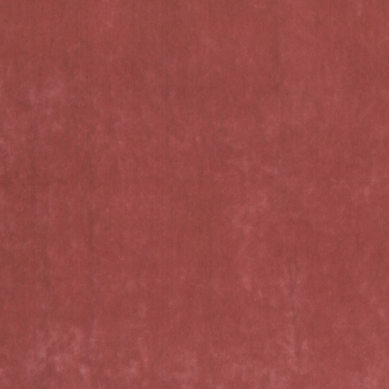 Close view of muted brick-red fabric with a softly mottled, subtly napped surface