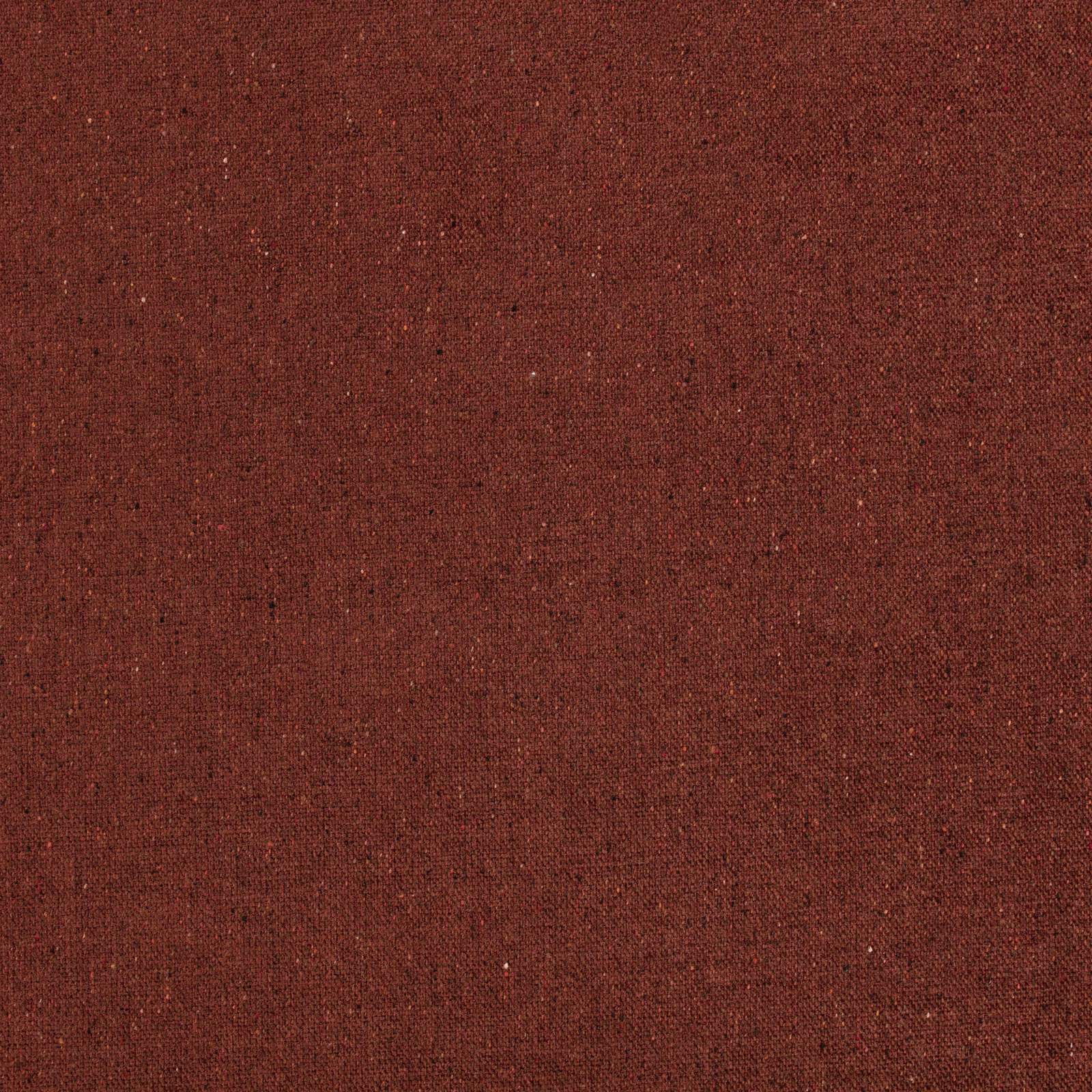 Close view of warm burnt-orange woven textile with fine dark flecks