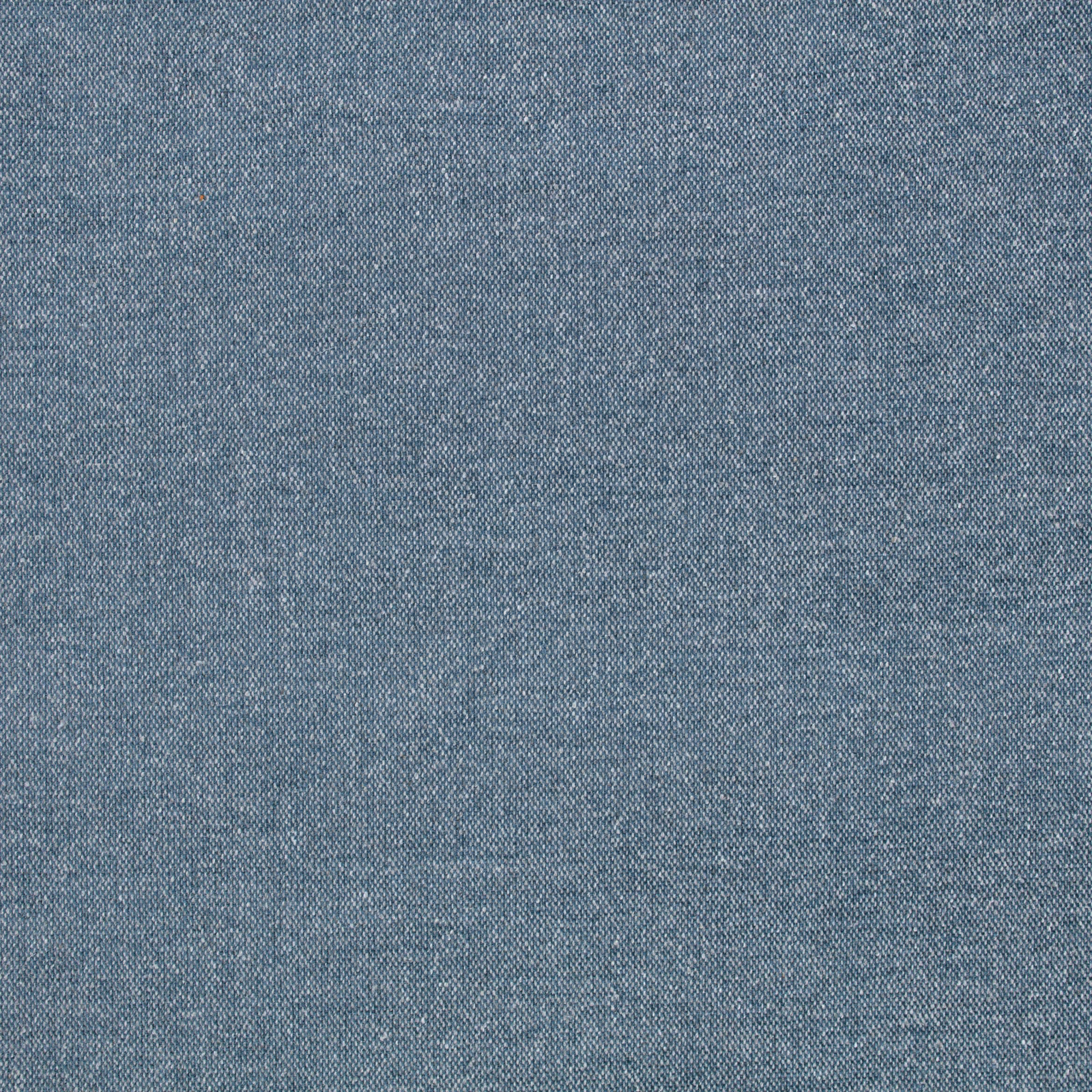 Close-up of muted denim-blue fabric with fine flecked woven texture