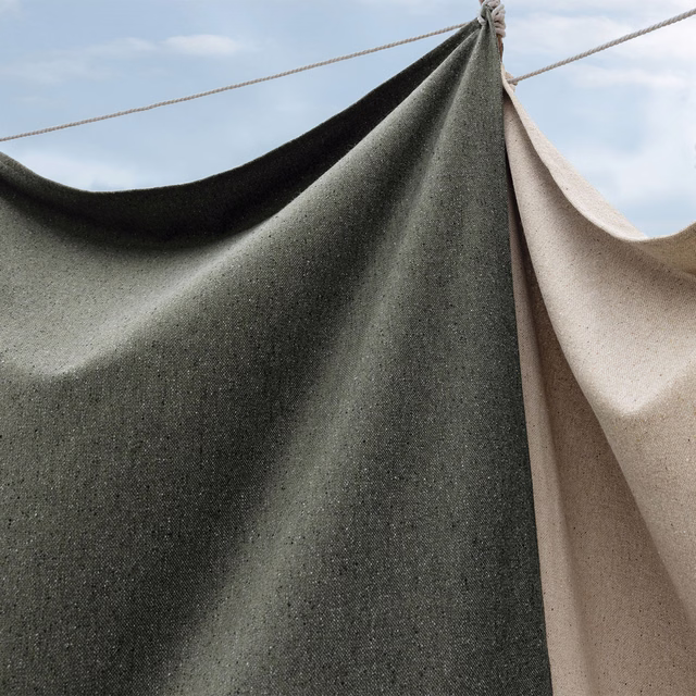 Dark khaki-green finely flecked weave hanging in broad, sculptural folds