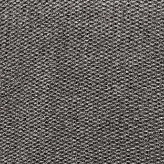 Close-up of charcoal black woven fabric with fine grey flecks and tactile texture