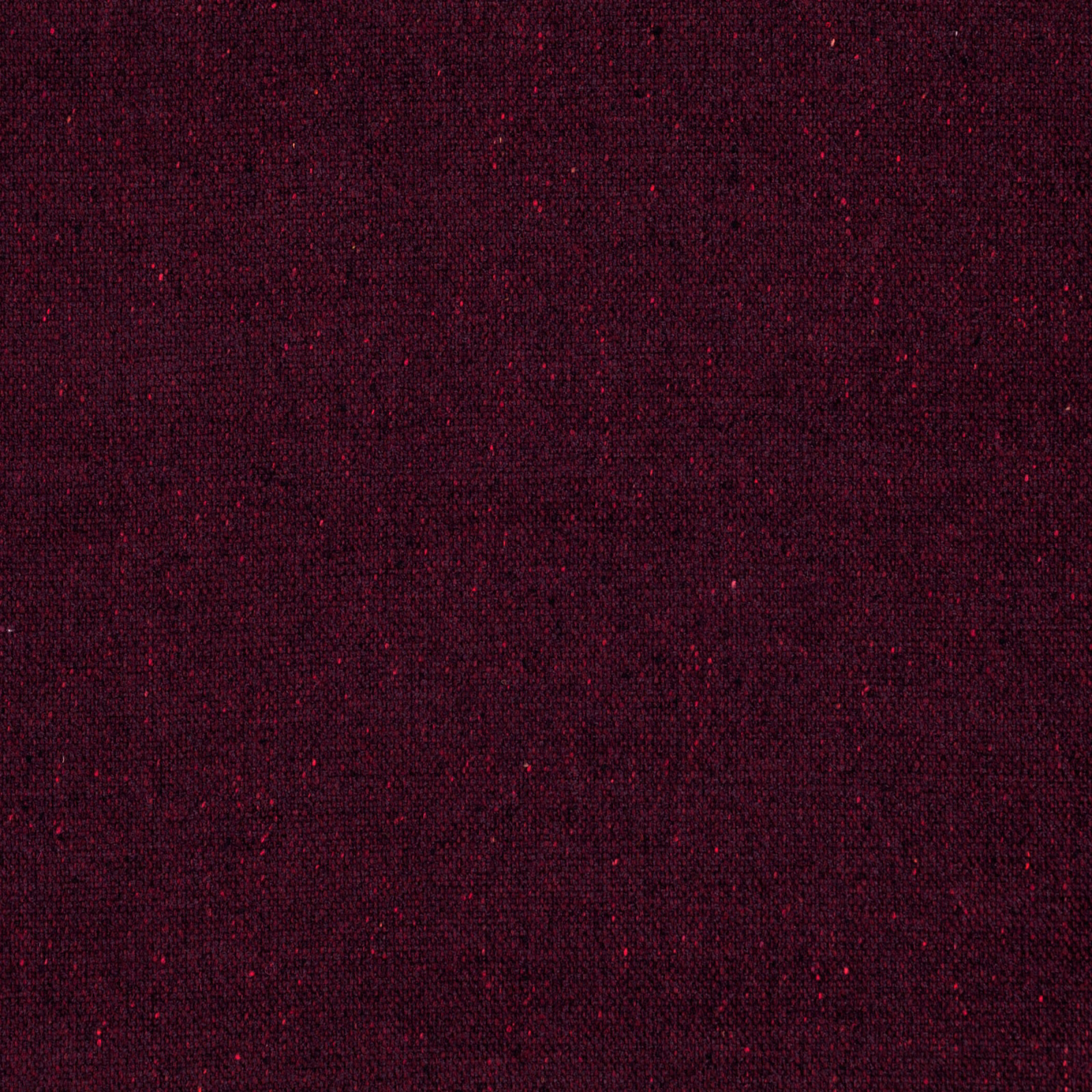 Deep ruby textile with near-black flecks and fine, compact woven texture