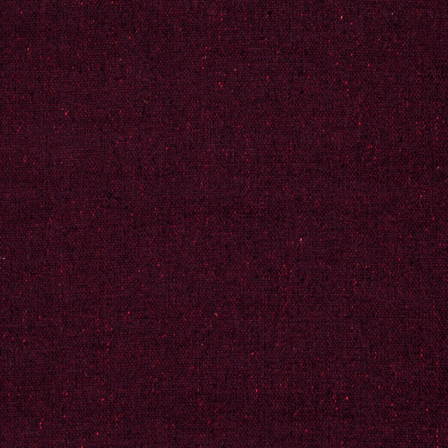 Deep ruby textile with near-black flecks and fine, compact woven texture